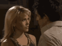 a man and a woman are looking into each other 's eyes