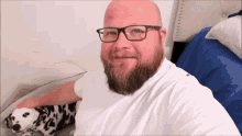 a bald man with a beard wearing glasses and a white shirt