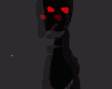 a skeleton with red eyes is standing in the dark and pointing at the camera .