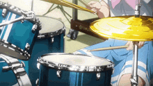 a person playing a drum set with a cymbal in the foreground