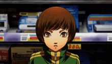 a girl in a green and yellow jacket stands in front of a shelf with 980 on it