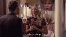 a woman says " i eat everything " in front of a man