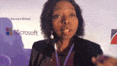 a woman stands in front of a microsoft logo