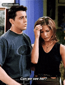 a man and a woman are standing next to each other and the woman says can we see her ?