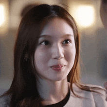 a close up of a woman 's face with a slight smile on her face