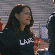 a woman wearing a shirt that says lapd smiles