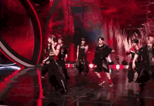 a man wearing a black tank top with the word boots on it is dancing .