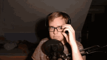a man wearing glasses and headphones looks at the camera