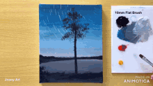 a painting of a tree is on a wooden table next to a palette