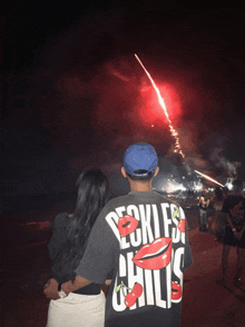 a man wearing a shirt that says ' reckless chili 's ' on it