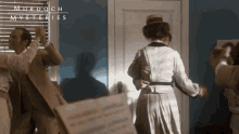 a group of people are dancing in a room with murdoch mysteries written in the corner