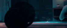 a cartoon cat with glowing eyes is laying on the floor in a dark room