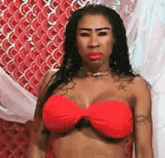 the woman is wearing a red bikini top and a choker .