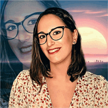 a woman wearing glasses and a floral shirt is smiling