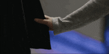 a close up of a person 's arm holding a black object