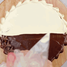 a cake with a white frosting and chocolate frosting