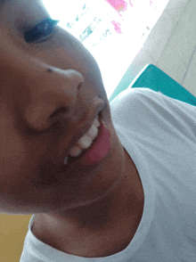 a close up of a person 's face with a white shirt with the word puma on it