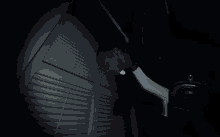 a man with a flashlight looking through a window