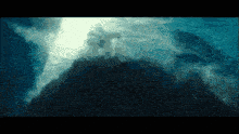 a dark blue background with a few clouds in the sky