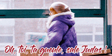 a woman in a purple jacket stands in front of a window with the words oh toi ta quente sale judas