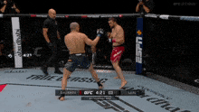 two men are fighting in a boxing ring and the ufc fight pass is displayed