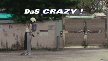a woman standing in front of a building with the words das crazy written on the top