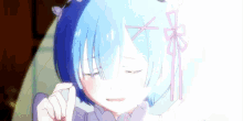 a close up of a anime girl with blue hair and a pink bow on her hair .