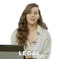 a woman sitting in front of a tablet with the word legal written on it