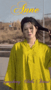 a woman in a yellow shirt with the name anne written above her