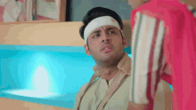 a man with a bandage on his head looks at another man