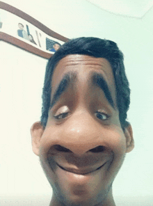 a man making a funny face in front of a framed picture