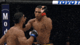 two men in a boxing ring with a banner that says toyot