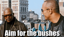 two men are standing next to each other with the words aim for the bushes above them