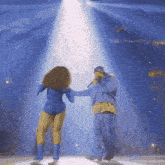 a man singing into a microphone while a woman dances in front of him