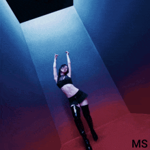 a woman is standing in a dark room with the letters ms on the bottom right