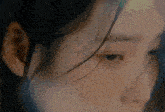 a close up of a woman 's face with wet hair on her forehead