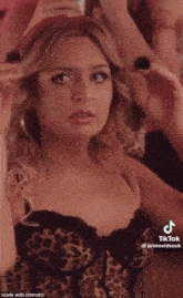 a woman in a leopard print corset has tiktok written on the bottom