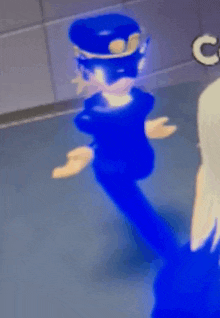a blue cartoon character is standing in a room with a hat on .