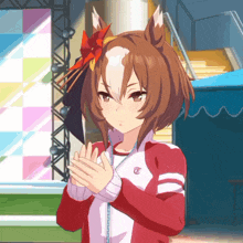 a girl in a red jacket with the letter t on her chest