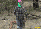 a man wearing a gas mask walking a dog in a field