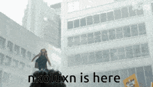 a sign that says nkoluxn is here is in front of a building