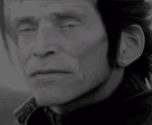 a close up of a man 's face with a serious look on his face
