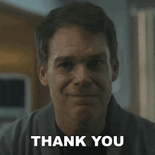 a man is smiling with the words thank you below him