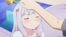 a person touching a girl 's forehead with a watermark of anime