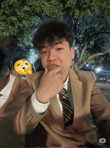a man in a suit and tie with a smiley face behind him