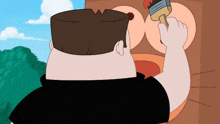 a man in a black shirt is holding a paintbrush
