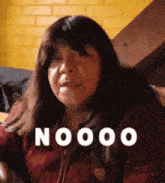 a woman is making a funny face with the word nooo written above her