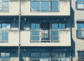 a building with a balcony and a sign that says ok on it
