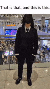 a person in a suit with a mask on their face is standing in a mall