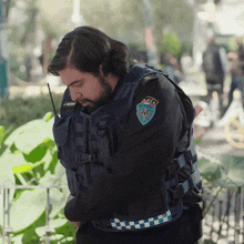 a police officer wearing a vest that says policia on it